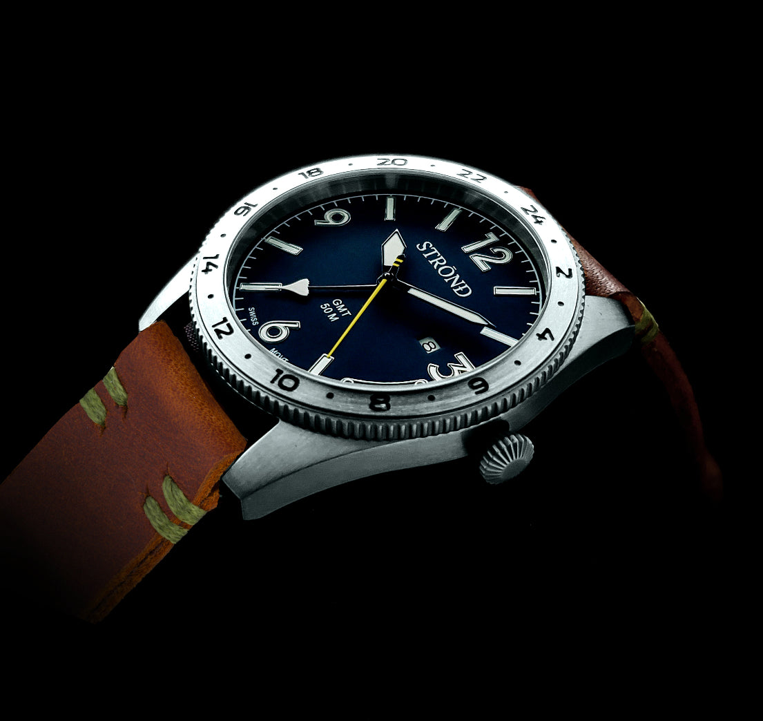Watch with a blue dial and brown leather strap on a black background