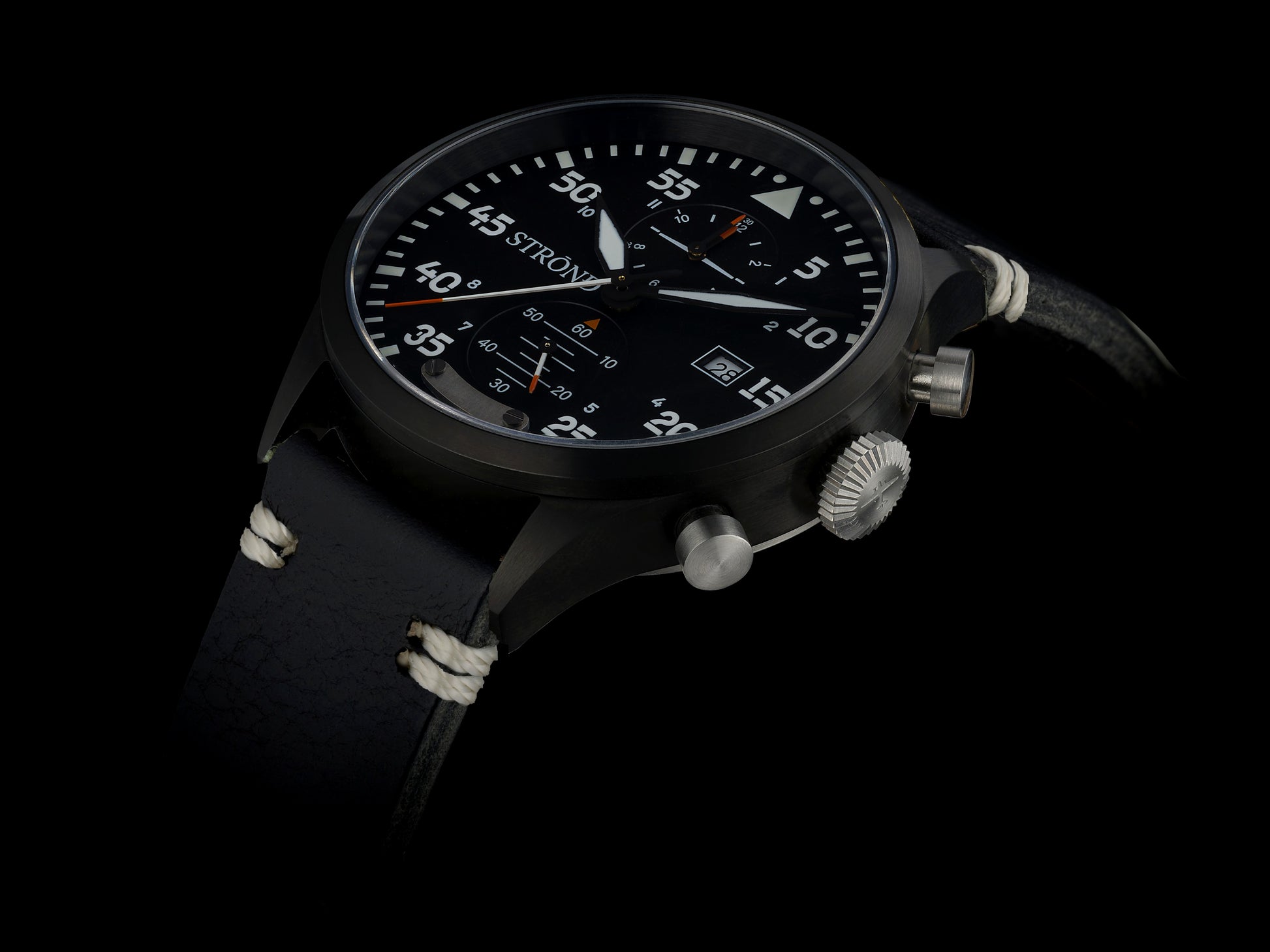 Black wristwatch with detailed face on a black background