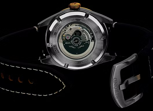 Close-up of a watch with visible brand name on a black background