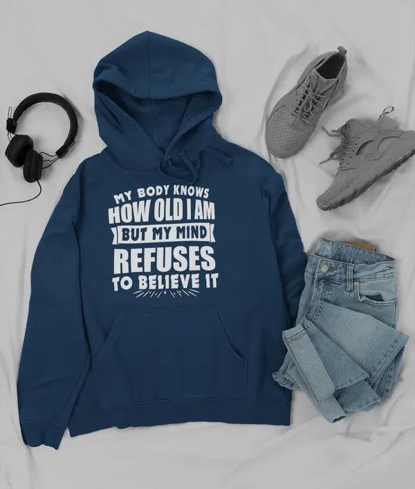 My Body Knows How Old I Am But My Mind Refuses to Believe It Hoodie by Merch