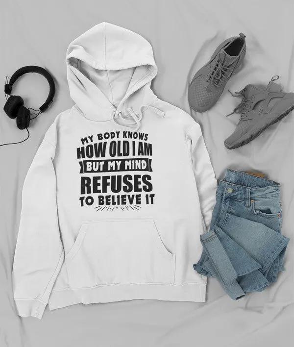 My Body Knows How Old I Am But My Mind Refuses to Believe It Hoodie by Merch